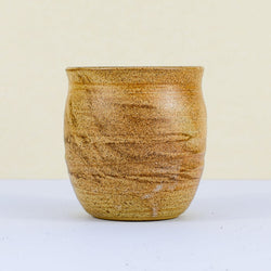 Handmade clay kulhar with a textured, earthy brown and beige swirl glaze.