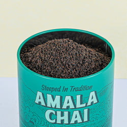 Amala Chai Assam black tea tin. Front view, close up of tea open with tea