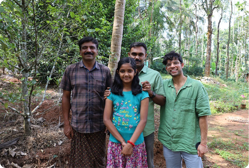 A photo of four people smiling, one is Akhil and the other three are a family. This photo shows that Akhil working directly with his suppliers.